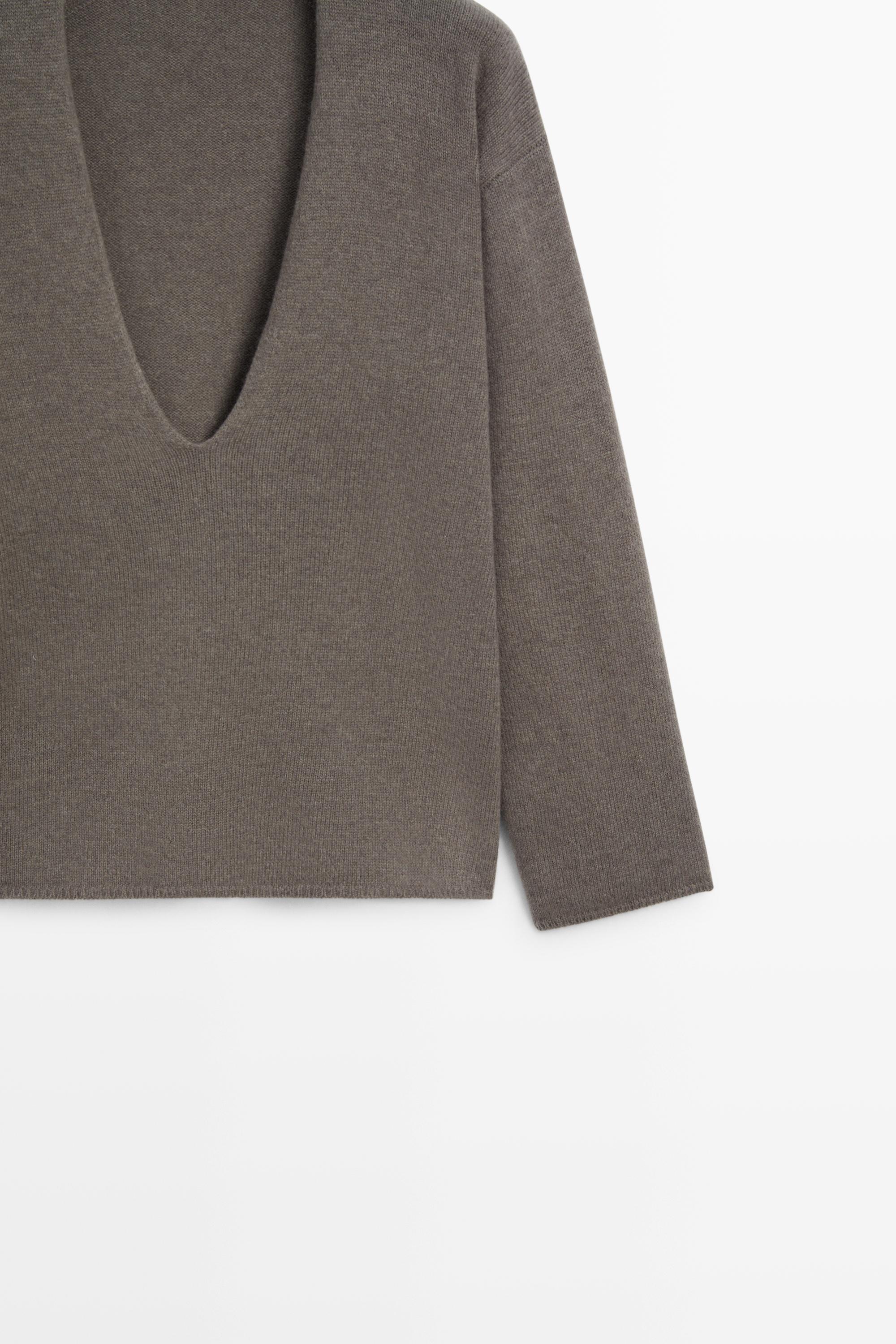 Long-line knit sweater with neckline detail